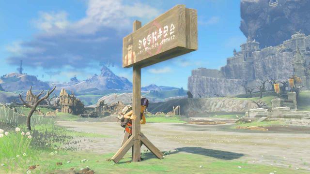 A funny-looking character strains to hold up a sign bearing the face of a burly boss in Zelda: Tears of the Kingdom