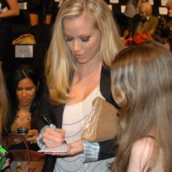 Kendra signs an autograph for a young girl from the audience.