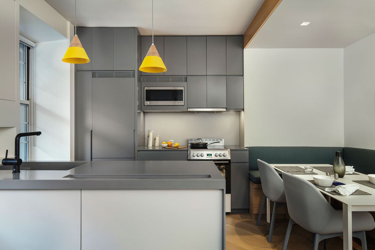 A kitchen with gray cabinets by General Assembly