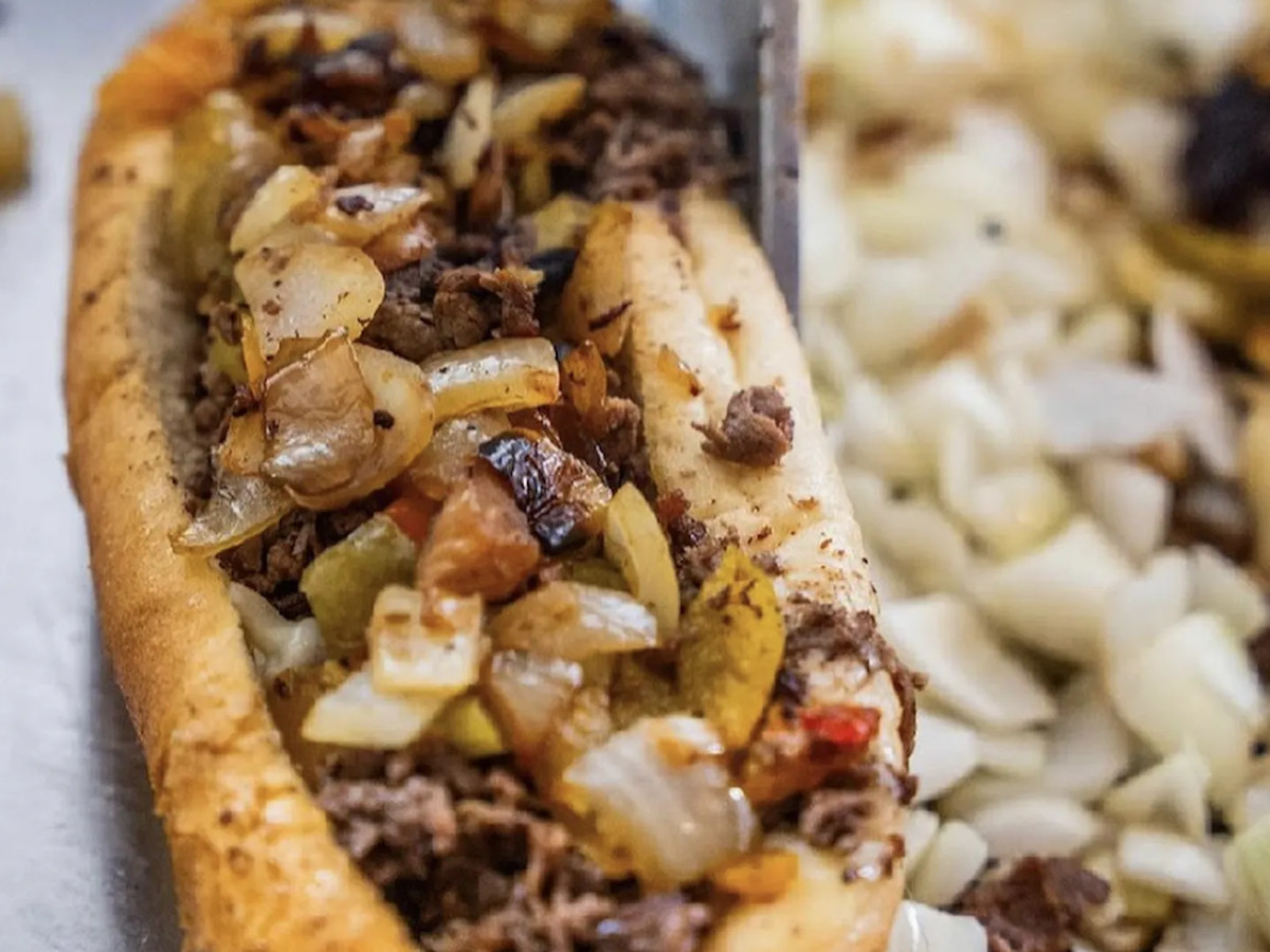 Cheesesteak with fried onions and peppers.