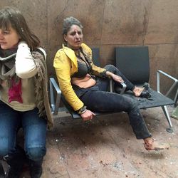 In this photo provided by Georgian Public Broadcaster and photographed by Ketevan Kardava two women wounded in Brussels Airport in Brussels, Belgium, after explosions were heard Tuesday, March 22, 2016. A developing situation left at least 26 people dead in explosions that ripped through the departure hall at Brussels airport Tuesday, police said. All flights were canceled, arriving planes were being diverted and Belgium's terror alert level was raised to maximum, officials said.