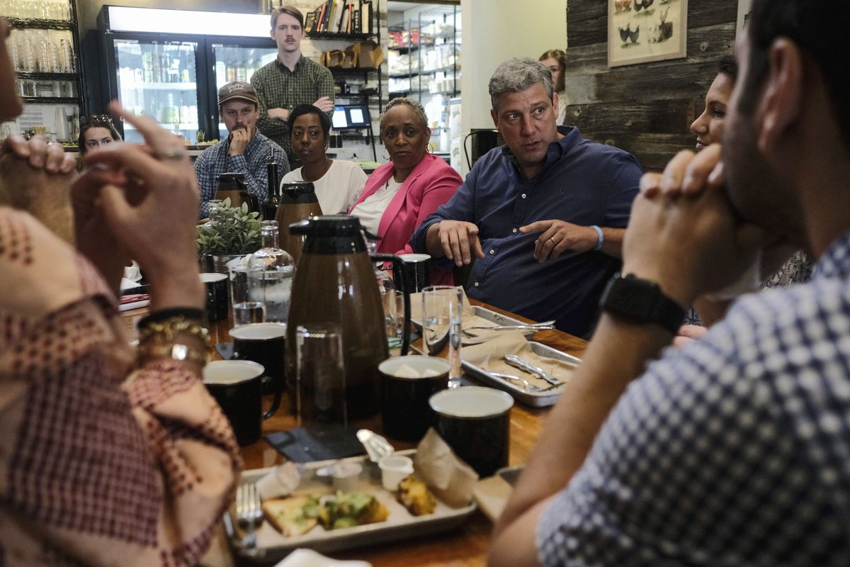 Ryan, grey haired in a navy button shirt, sits at a crowded table covered in coffee flasks and the carby remnants of breakfast; a diverse group of entrepreneurs listens intently to what he’s saying. 