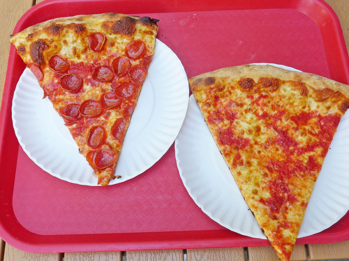 A pair of pizza slices on an orange plastic tray.
