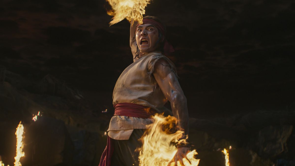 Ludi Lin screams as he prepares a burning-hands attack in his role as Liu Kang in 2021’s Mortal Kombat