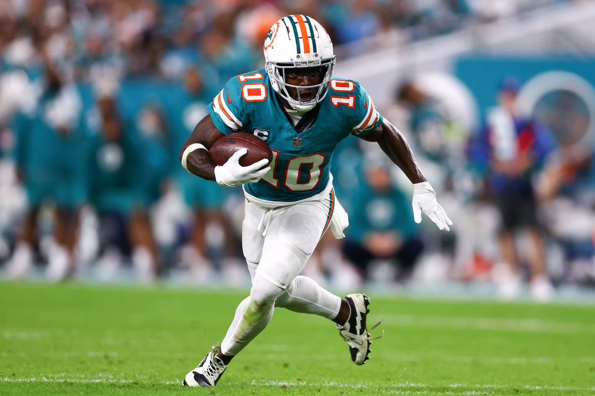 Tyreek Hill #10 of the Miami Dolphins carries the ball against the Dallas Cowboys during the fourth quarter of the game at Hard Rock Stadium on December 24, 2023 in Miami Gardens, Florida.