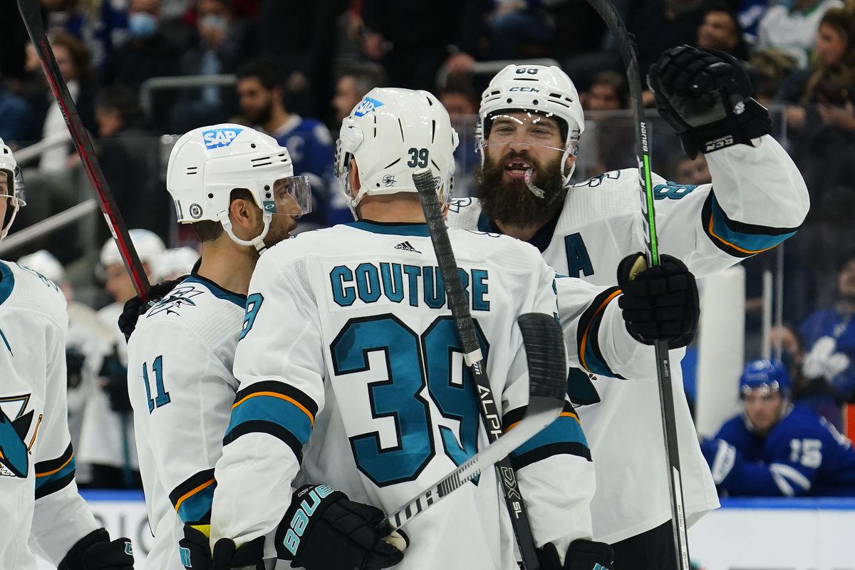 Oct 22, 2021; Toronto, Ontario, CAN; San Jose Sharks defenseman Brent Burns (88) and forward Andrew Cogliano (11) congratulate forward Logan Couture (39) on his second goal of the game against the Toronto Maple Leafs during the third period at Scotiabank Arena.