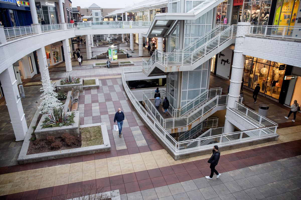 Shoppers walk around Oakbrook Center on Friday afternoon, Dec. 24, 2021, a day after two men open fired at each other at the mall.
