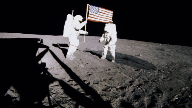 Two astronauts standing beside an American flag on the Moon in For All Mankind.