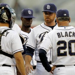 San Diego Padres relief pitcher Tim Stauffer, second from right, fields questions on his condition after getting hit by a ball playing against the Los Angeles Dodgers in the first inning during a baseball game Friday, June 21, 2013, in San Diego. Padres catcher Nick Hundley (4) and manager Bud Black (20) give the questions with shortstop Pedro Ciriaco, second from left, all meet at the mound. 