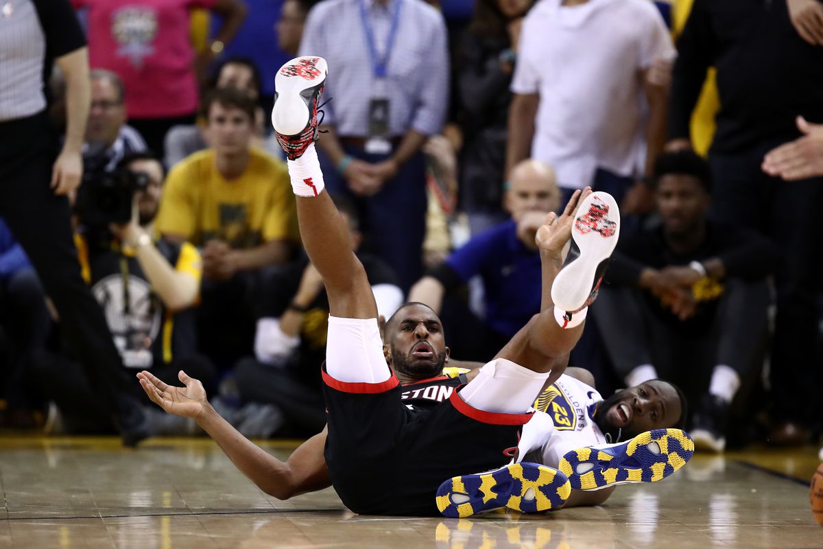 Chris Paul and Draymond Green on the ground after falling over 