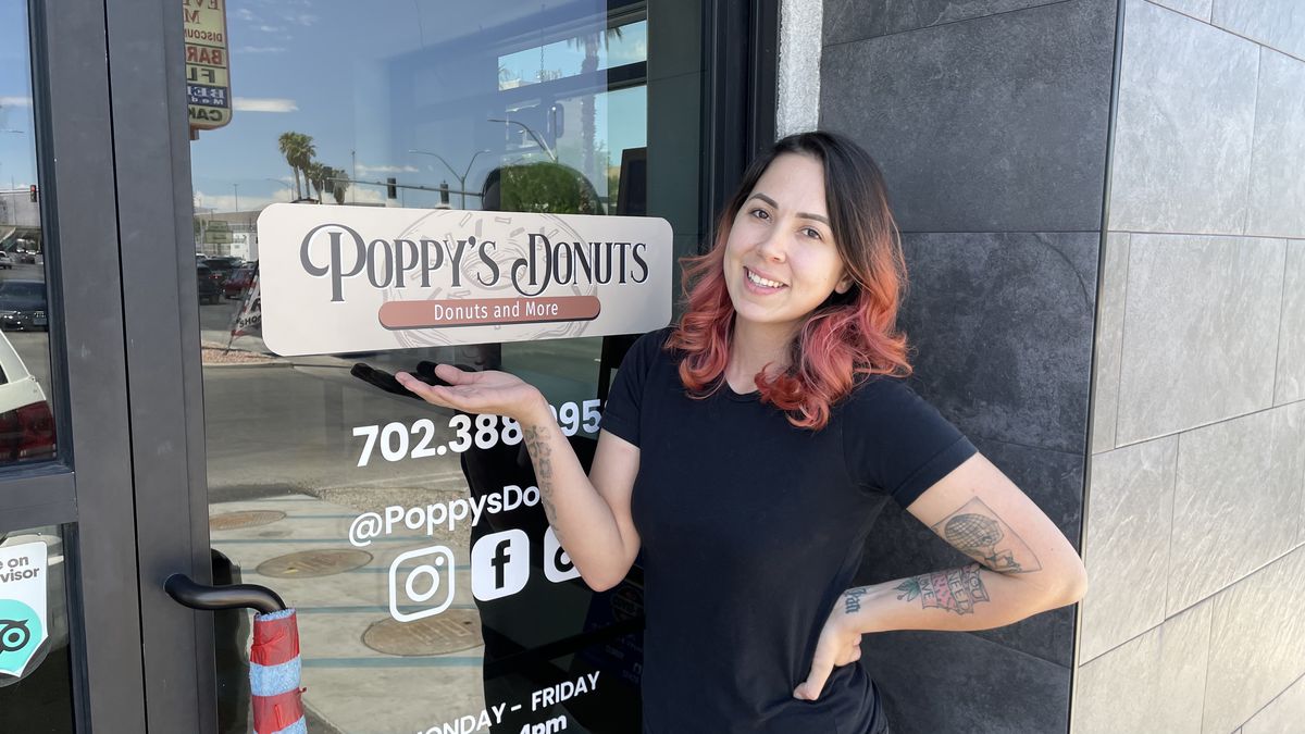 Tanya Solares poses in front of her store, Poppy’s Donuts