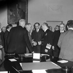 Harry S. Truman, second from left, after being sworn in as president to succeed the late Franklin D. Roosevelt, is congratulated by Fleet Admiral William D. Leahy, right, chief of staff to the commander in chief, at the White House, Washington, D.C., April 12, 1945. Looking on (center) is Rep. John W. McCormack (D-Mass.). The man at left is unidentified.