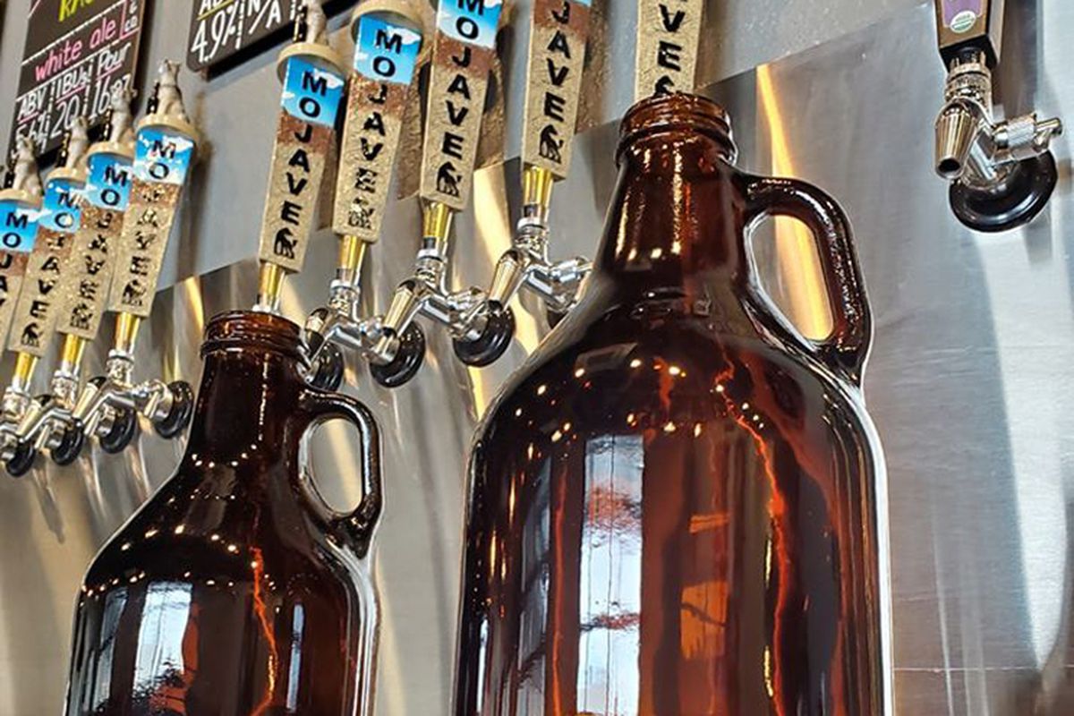 A collection of growlers on display in Water Street’s Mojave Brewing Company.