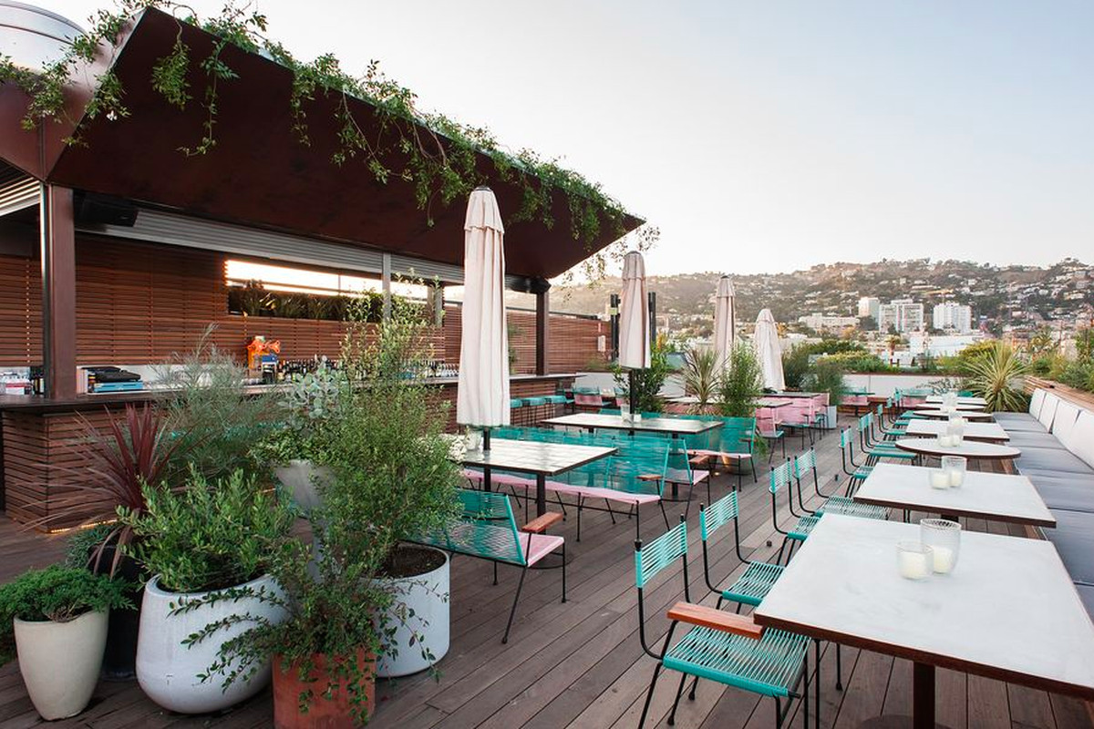 An outdoor, rooftop bar facing the Hollywood Hills.