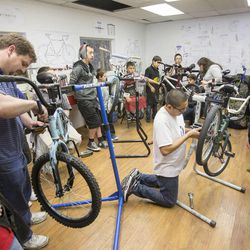 Adults and kids involved in Peer Court work to assemble bikes at the Bicycle Collective in Salt Lake City on Wednesday, March 12, 2014.