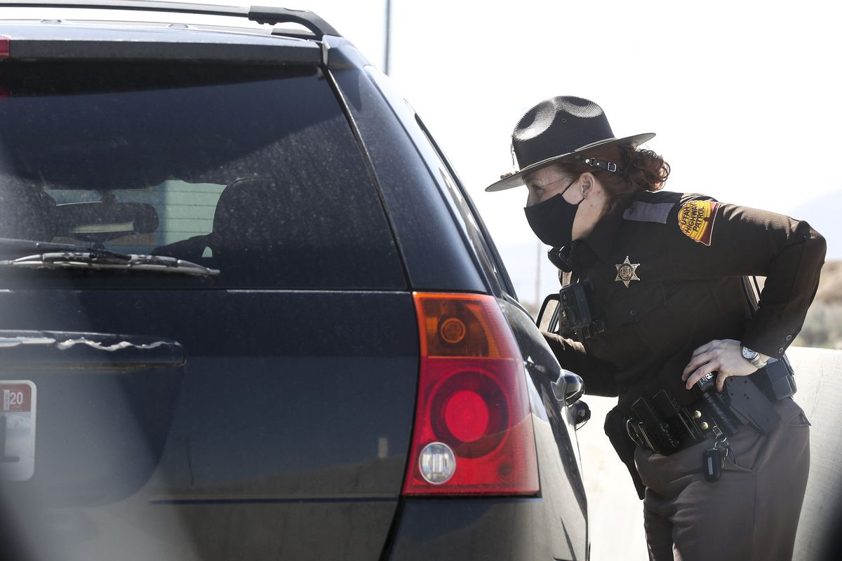 Utah Highway Patrol trooper Geri Tew speaks with a motorist after pulling them over for using a cellphone while driving.