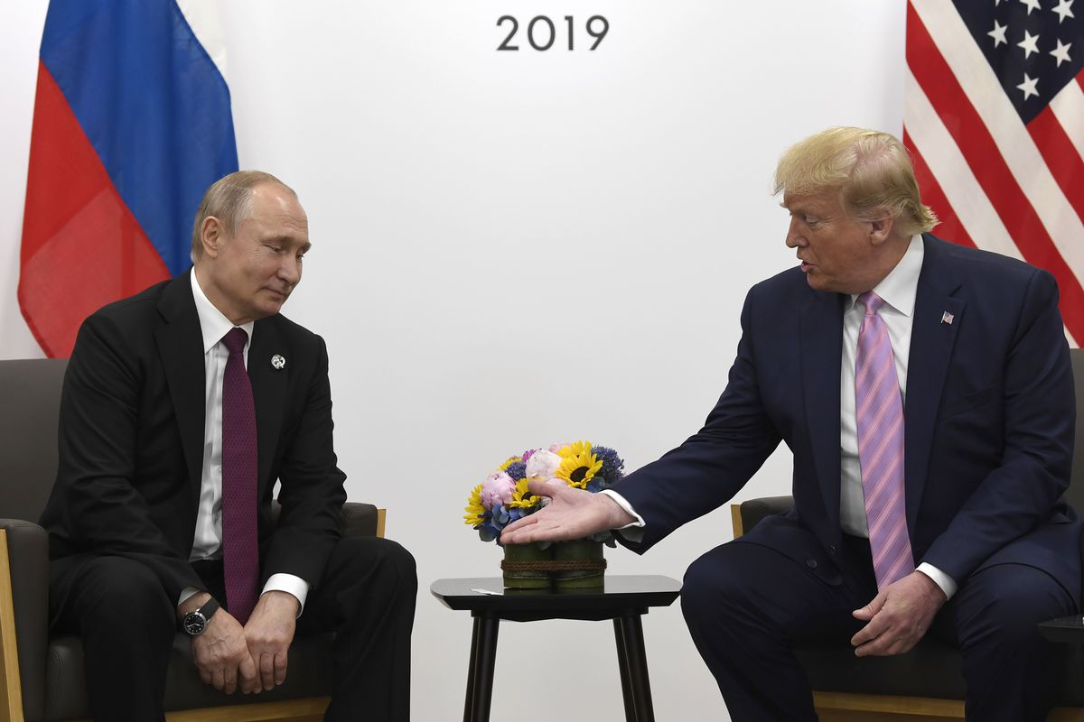 President Donald Trump reaching out to shake hands with Russian President Vladimir Putin.