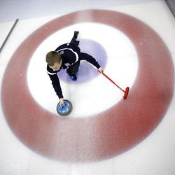 Jeff Isaacson of Gilbert, Minn., slides through the house as he prepares to throw the rock during curling practice at the 2010 Olympics in Vancouver, British Columbia, on Saturday.