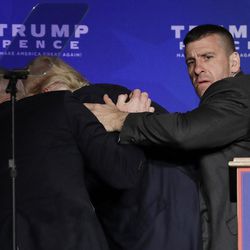 Secret Service agents rush Republican presidential candidate Donald Trump off the stage during a campaign rally in Reno, Nev., on Saturday, Nov. 5, 2016. He returned to the podium afterwards. 