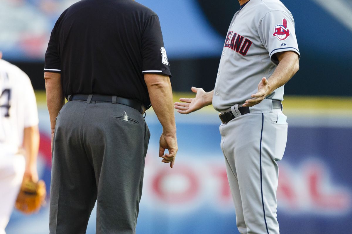 August 3, 2012; Detroit, MI, USA; Cleveland Indians manager Manny Acta (11) talks to umpire Joe West during the first inning against the Detroit Tigers at Comerica Park. Mandatory Credit: Rick Osentoski-US PRESSWIRE