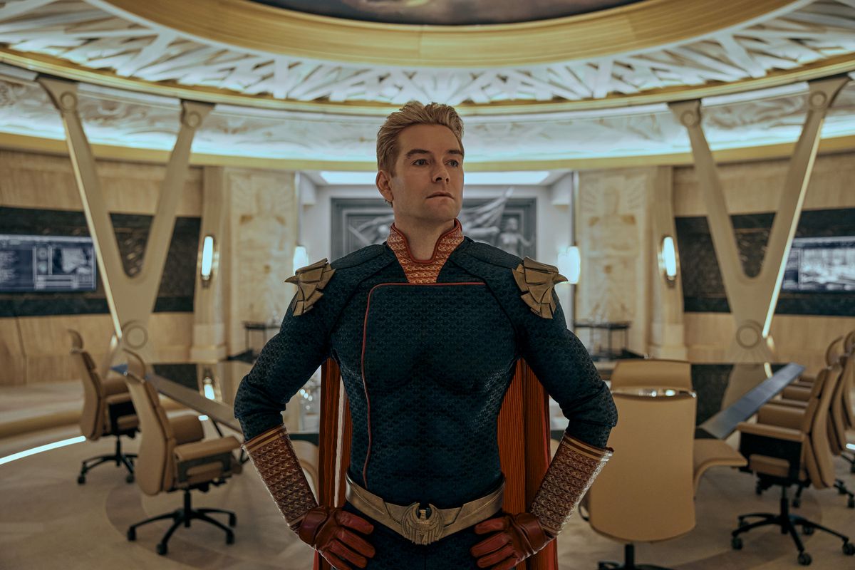 Homelander stands in the Seven’s meeting room in a hero pose in season 3 of The Boys.