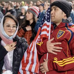 Shazia Kakaie, left, and her husband, Azim Kakaie, stand during the national anthem before a soccer match between Real Salt Lake and Portland at Rio Tinto Stadium in Sandy on Wednesday, Nov. 3, 2021.