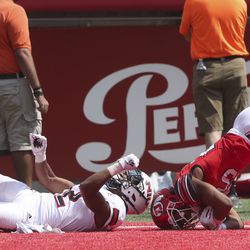Utah Utes wide receiver Jaylen Dixon (25) tumbles in the end zone after making a touchdown catch Northern Illinois Huskies cornerback Devin Haney (12) during second half action in the University of Utah versus Northern Illinois football game at Rice-Eccles Stadium in Salt Lake City on Saturday, Sept. 7, 2019.