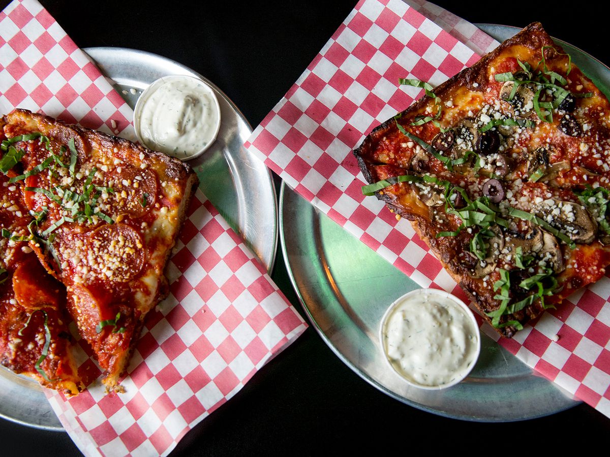 Two squares of Ranch Pizza sit on plates at the now-closed Poison’s Rainbow
