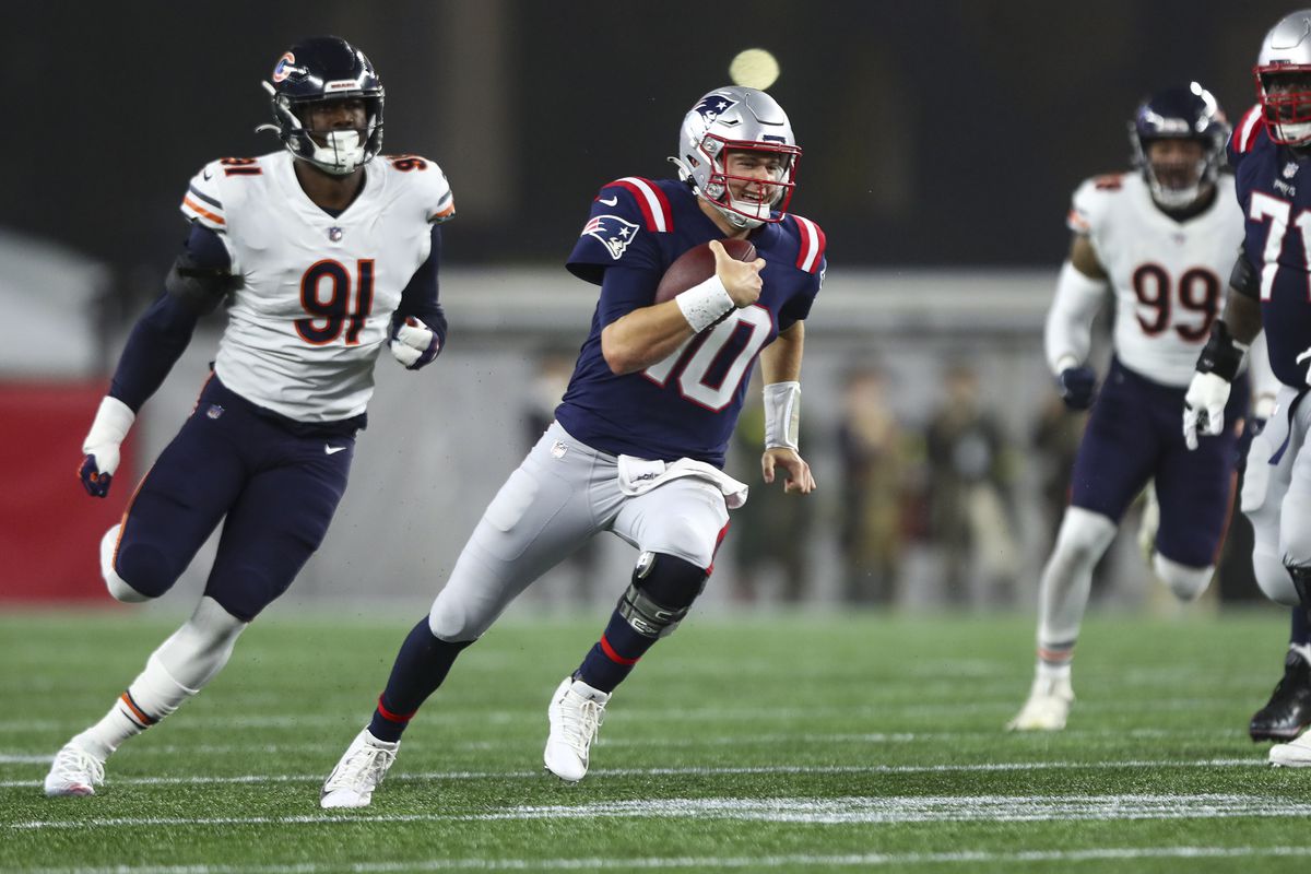 Mac Jones #10 of the New England Patriots carries the ball during an NFL football game against the Chicago Bears at Gillette Stadium on October 24, 2022 in Foxborough, Massachusetts.