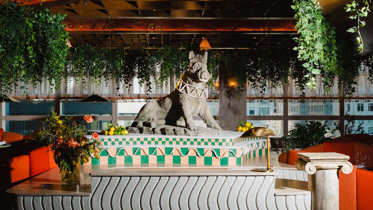 A statue of a wild boar — or is it a warthog? — is perched at the entrance of a restaurant.
