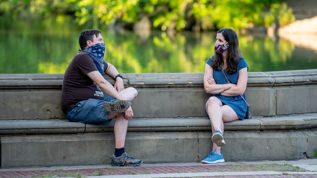 Two people sit socially distanced on a bench at Bethesda Terrace in Central Park as New Yorkers adjust to the new realities of phase 3 of reopening on July 13.