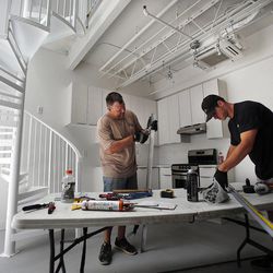 Jeff Hobbs, left, and Tanner Kemp work in a studio unit at Broadway Park Lofts in Salt Lake City, Thursday, July 10, 2014.