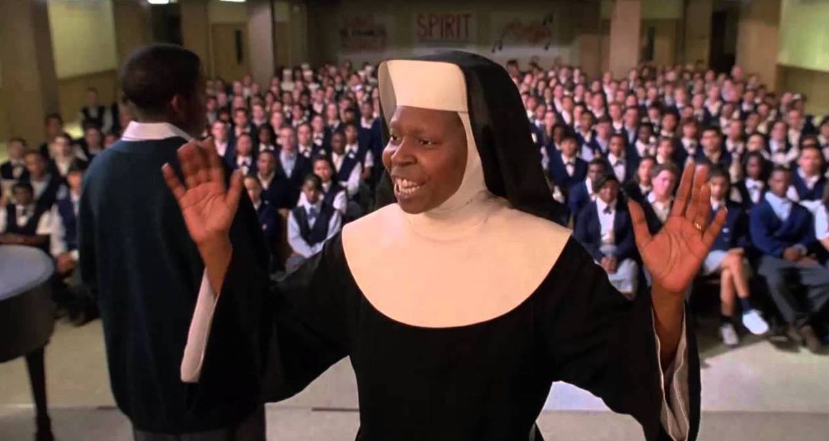 whoopi leads a choir of singing nuns but with her habit on