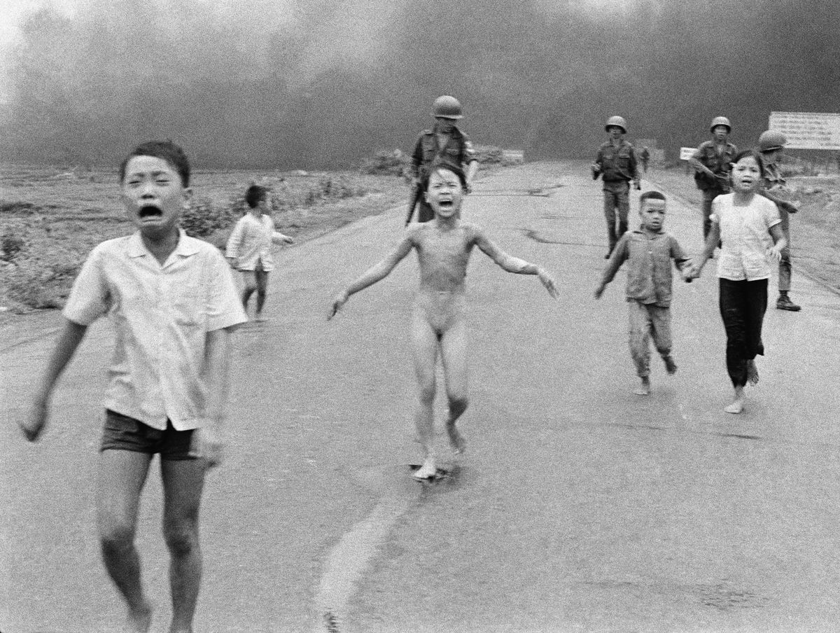 The June 8, 1972, photo of South Vietnamese forces following after terrified children, including 9-year-old Kim Phuc, center, as they run down Route 1 near Trang Bang after an aerial napalm attack on suspected Viet Cong hiding places. | AP Photo/Nick Ut