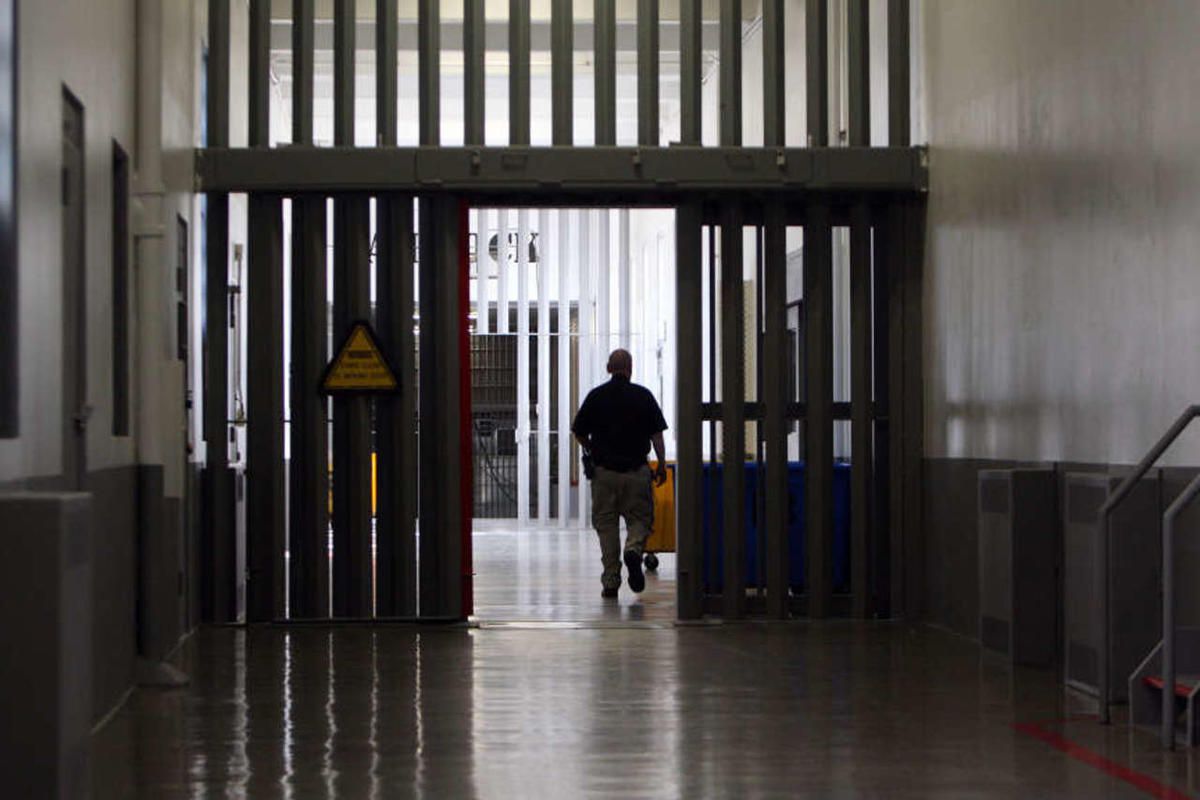 An officer walks in A Block at the Utah State Prison in Draper, Wednesday, March 5, 2014.