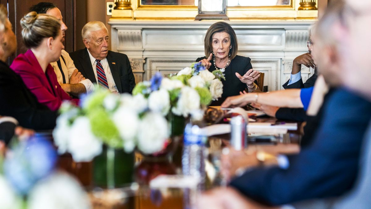 Speaker of the House Representative Nancy Pelosi sits at the head of a table at a meeting with her leadership and committee chairs.