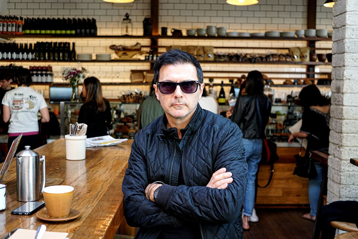 Chef Christophe Eme wearing sunglasses and posing with crossed arms at a restaurant in Los Angeles