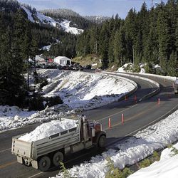 Trucks ferry snow to Cypress Mountain on Feb. 4. The site has been plagued with problems during the Games.