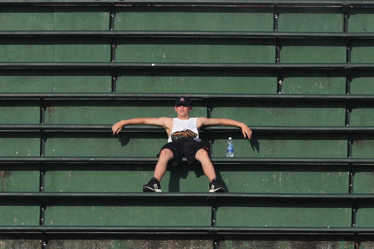 A fan sits in the right field bleachers during batting practice before a game between the Chicago Cubs and the Philadelphia Phillies at Wrigley Field in Chicago, Illlinois. (Photo by Jonathan Daniel/Getty Images)