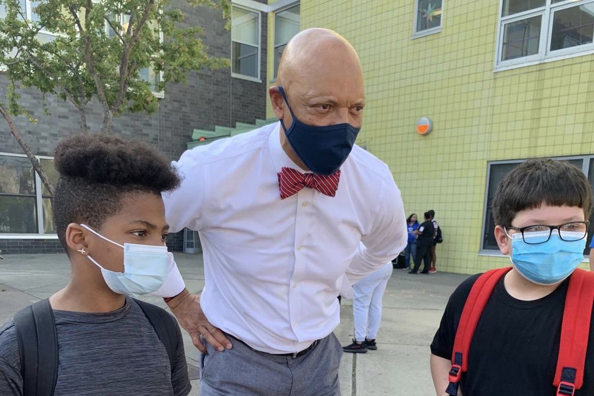 Philadelphia Superintendent William Hite with two students outside Hunter Elementary School