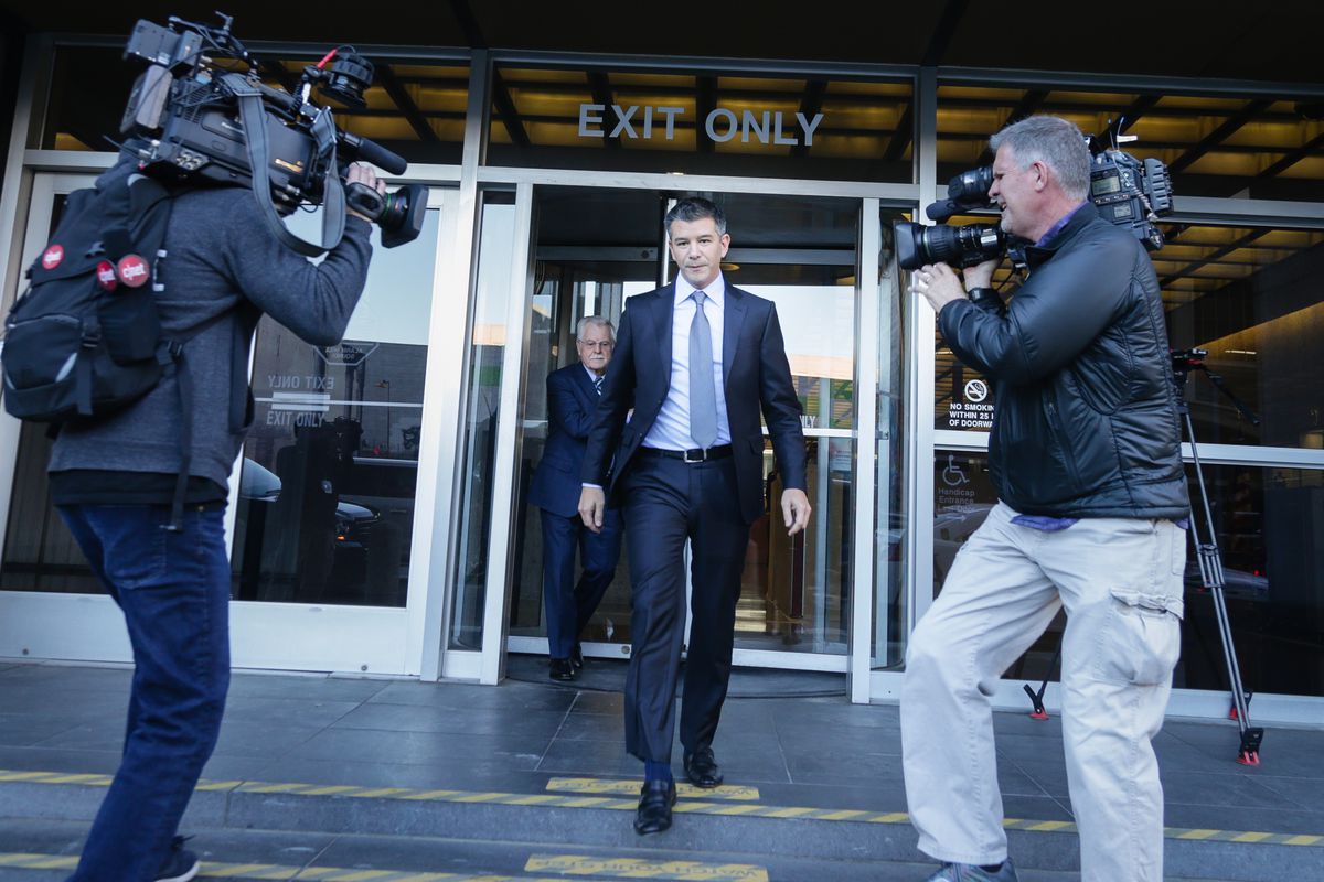 Travis Kalanick, Uber’s founder and ex-CEO, being confronted with TV cameras as he walks out of the courthouse.