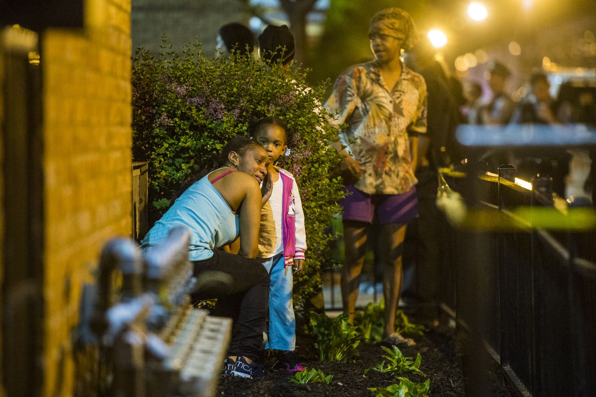 A woman cries near the scene of a fatal shooting Friday in the Cabrini Green neighborhood | Tyler LaRiviere/SunTimes