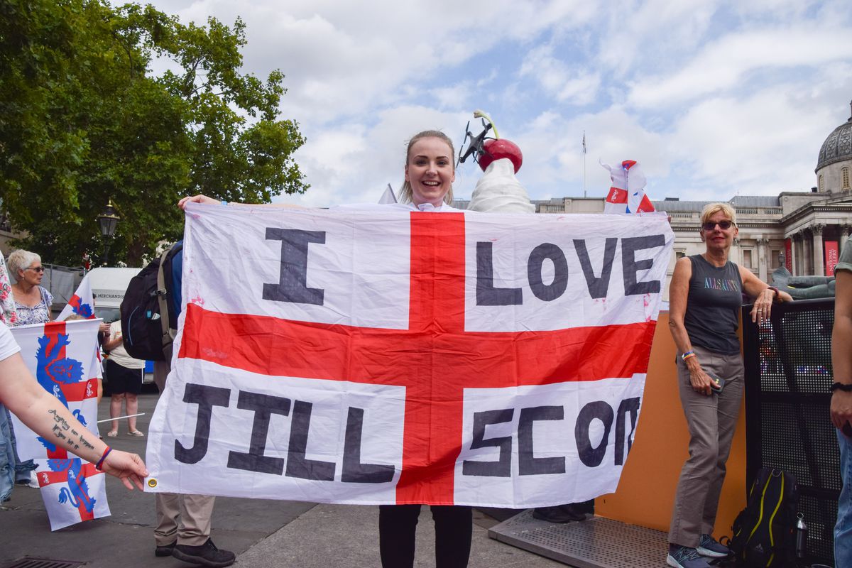 A fan holds an England flag with the message “I love (...