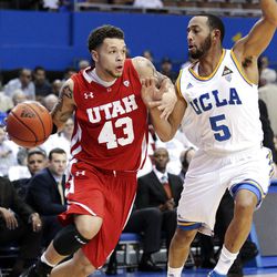 Utah guard Cedric Martin (left) drives to the basket as UCLA's Jerime Anderson defends in the first half.  