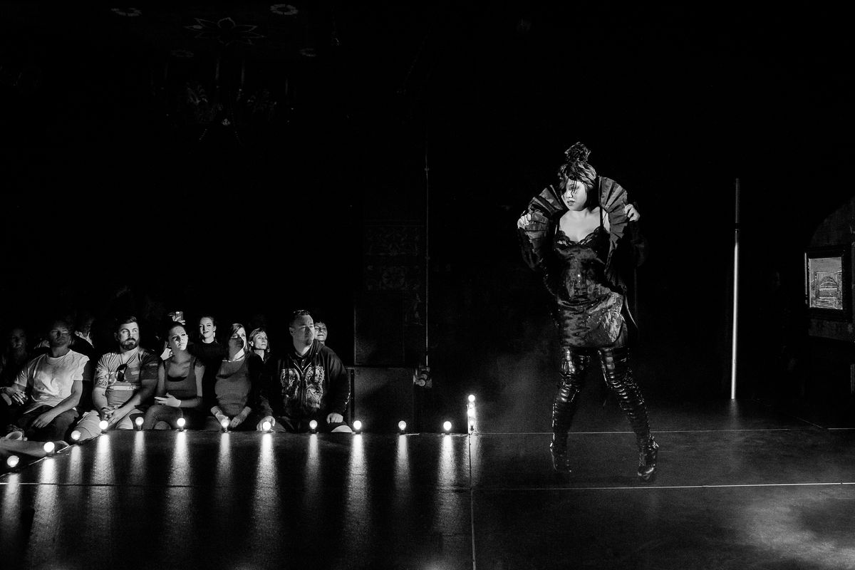 Hana Li onstage dancing as Eliza Cassan in a black-and-white photograph taken at Dallas Burlesque Festvial 2017 at HOB Dallas