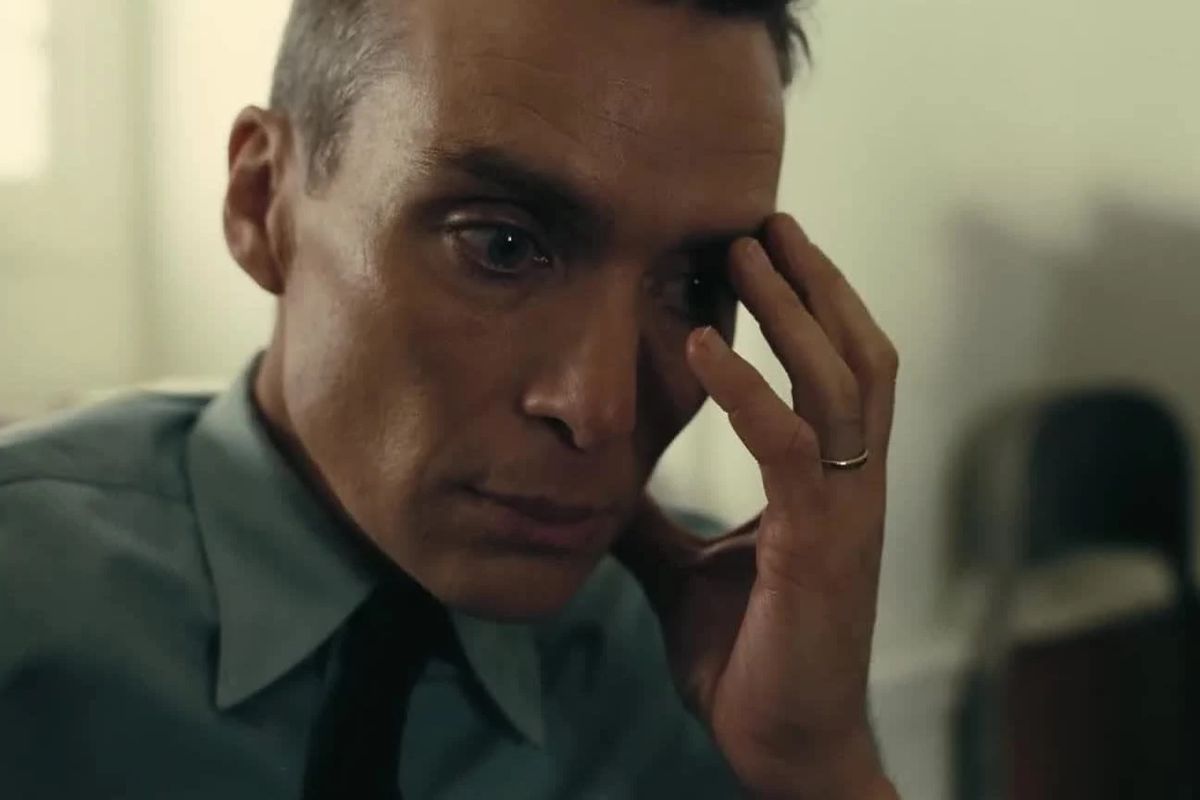 Cillian Murphy holds his hand over his eye as he contemplates horrors in Oppenheimer.