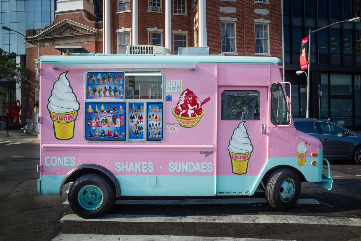 pink ice cream truck on a street 