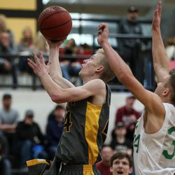 Emery's Kyson Stilson goes to the hoop ahead of South Summit's Kael Atkinson during a 3A boys basketball first round game at Wasatch High School in Heber City on Saturday, Feb. 17, 2018.