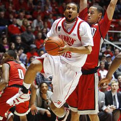 Utah's #15 Carlon Brown jumps around UNLV's Chace Stanback as Utah and UNLV play at the Huntsman Center, Wednesday.