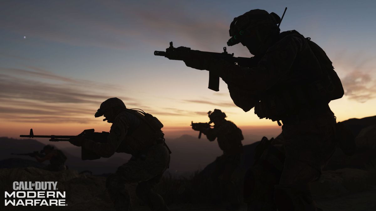 A group of heavily armed soldiers walk in front of a sunset